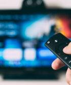 Una persona maneja el mando a distancia de su televisor.