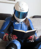 Motorista equipado leyendo un libro en un sofá
