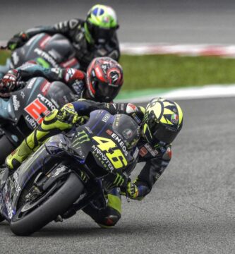 Valentino Rossi seguido de los dos pilotos del Petronas Yamaha SRT durante una carrera de MotoGP